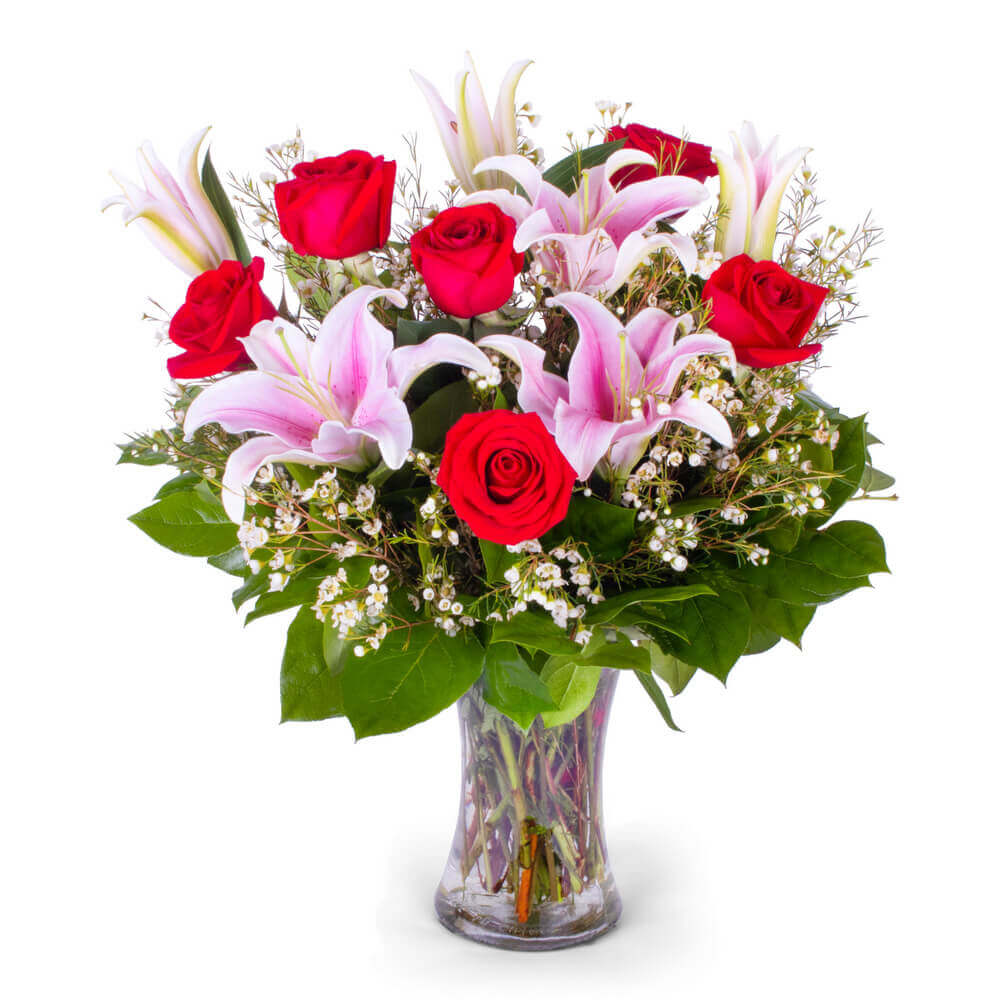 Bouquet of red roses and pink lilies in a clear vase from Joshua's Greenery Barrie florist