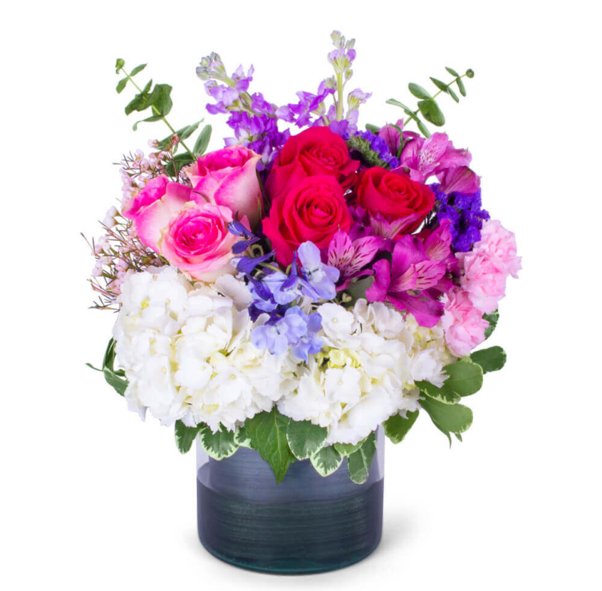 Colorful flower arrangement with roses, hydrangeas, and greens in a glass vase, Joshua's Greenery