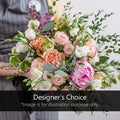 Florist holding a designer's choice bouquet with roses, peonies, and greenery at Joshua's Greenery Barrie.