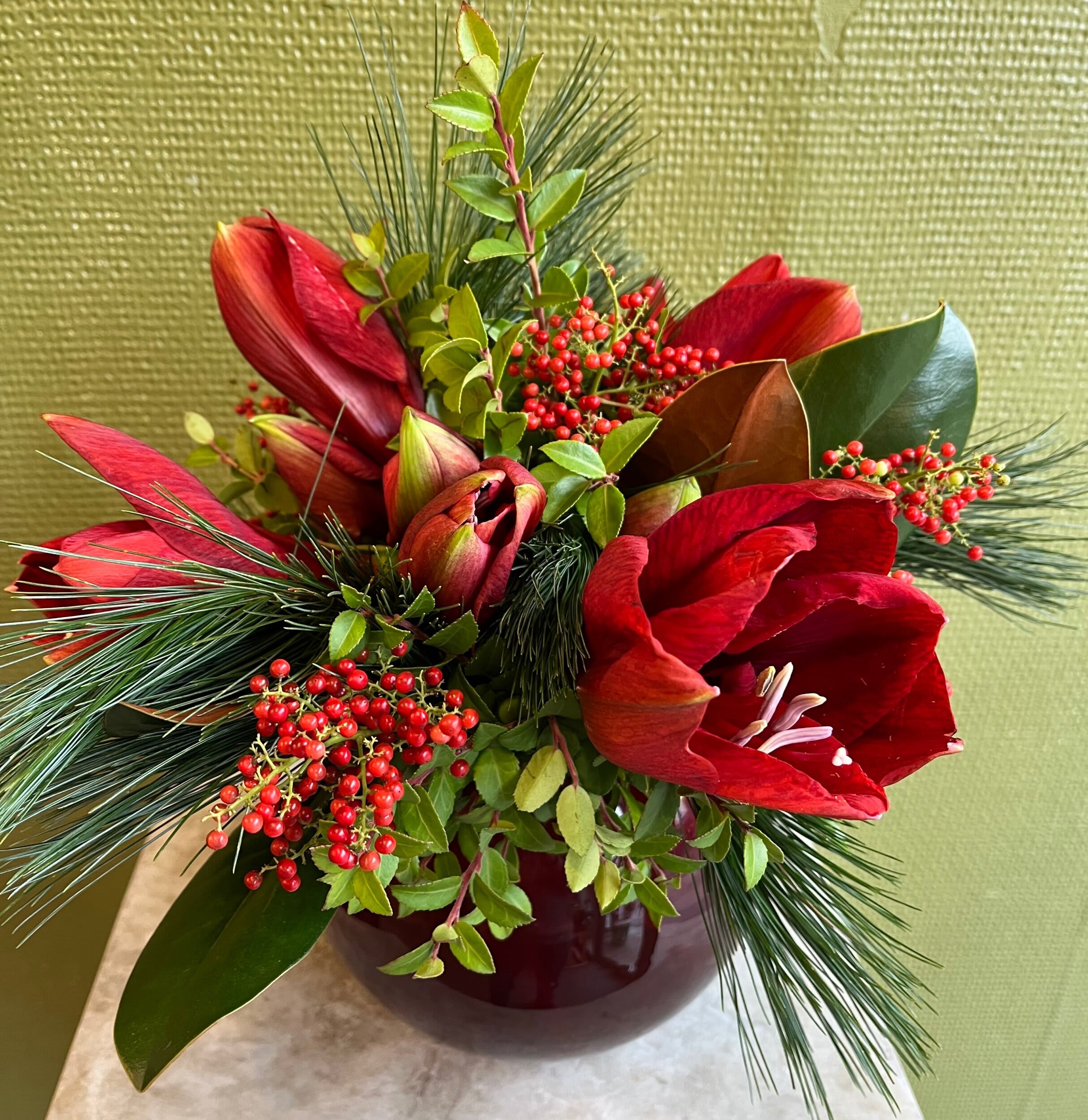 Red amaryllis and berries floral arrangement in vase by Joshua's Greenery Barrie Florist