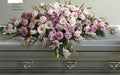 Pink and white sympathy casket spray with roses and lilies on a gray casket, Joshua's Greenery Barrie Florist