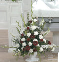 Red and white funeral flower basket arrangement by Joshua's Greenery in Barrie