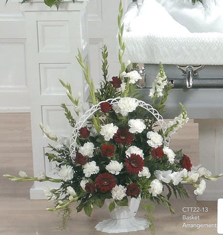 Red and white funeral flower basket arrangement by Joshua's Greenery in Barrie