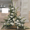 White floral fireside basket arrangement by Joshua's Greenery Barrie Florist on wooden floor