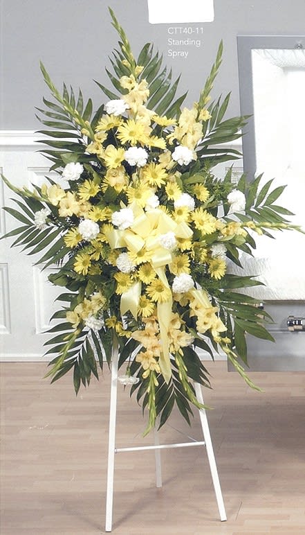 Yellow and white standing funeral spray with greenery on easel from Joshua's Greenery Barrie Florist