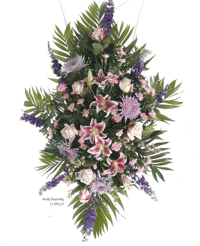 Pink and purple floral standing spray with lilies, roses, and greenery from Joshua's Greenery