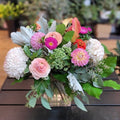 Fresh mixed flower arrangement with pink, white, and green blooms in a glass vase at Barrie florist