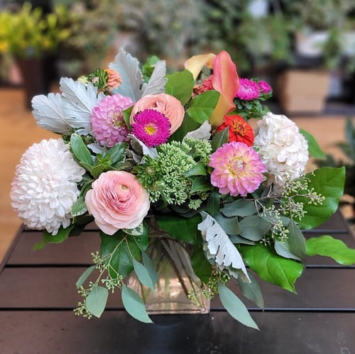 Fresh mixed flower arrangement with pink, white, and green blooms in a glass vase at Barrie florist