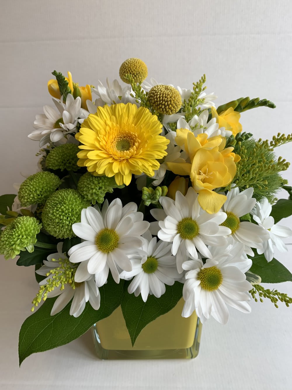 Yellow and white flower arrangement in green vase, Barrie florist Joshua's Greenery.
