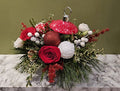 Festive holiday flower arrangement with red roses, white flowers, and ornaments on marble, Joshua's Greenery-Barrie Florist.