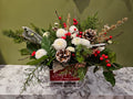 Festive floral arrangement with pinecones, white flowers, red berries, and greenery in a red sleigh, Joshua's Greenery Barrie Florist.