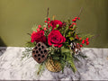 Festive floral arrangement with red roses, pine, and holiday accents in a gold vase, Barrie florist