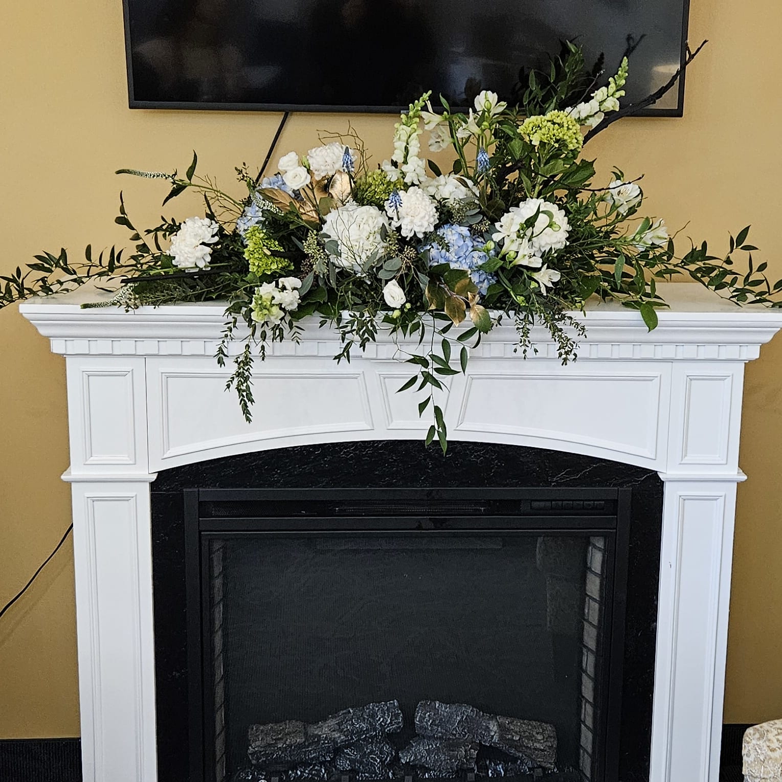 Elegant white and blue floral arrangement on a white mantel, Joshua's Greenery Barrie Florist