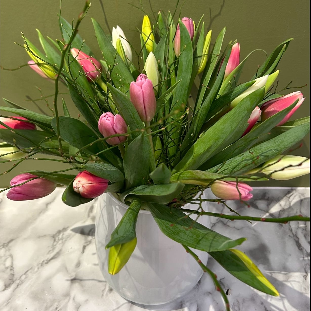 Pink and white tulip bouquet in white vase on marble surface, Joshua's Greenery Barrie Florist