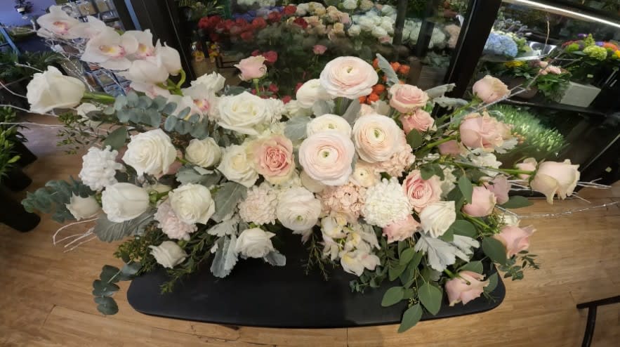 Elegant pink and white flower arrangement on display at Joshua's Greenery Barrie florist shop