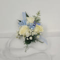 White rose corsage with baby’s breath, blue ribbon, and greenery from Joshua’s Greenery Barrie Florist