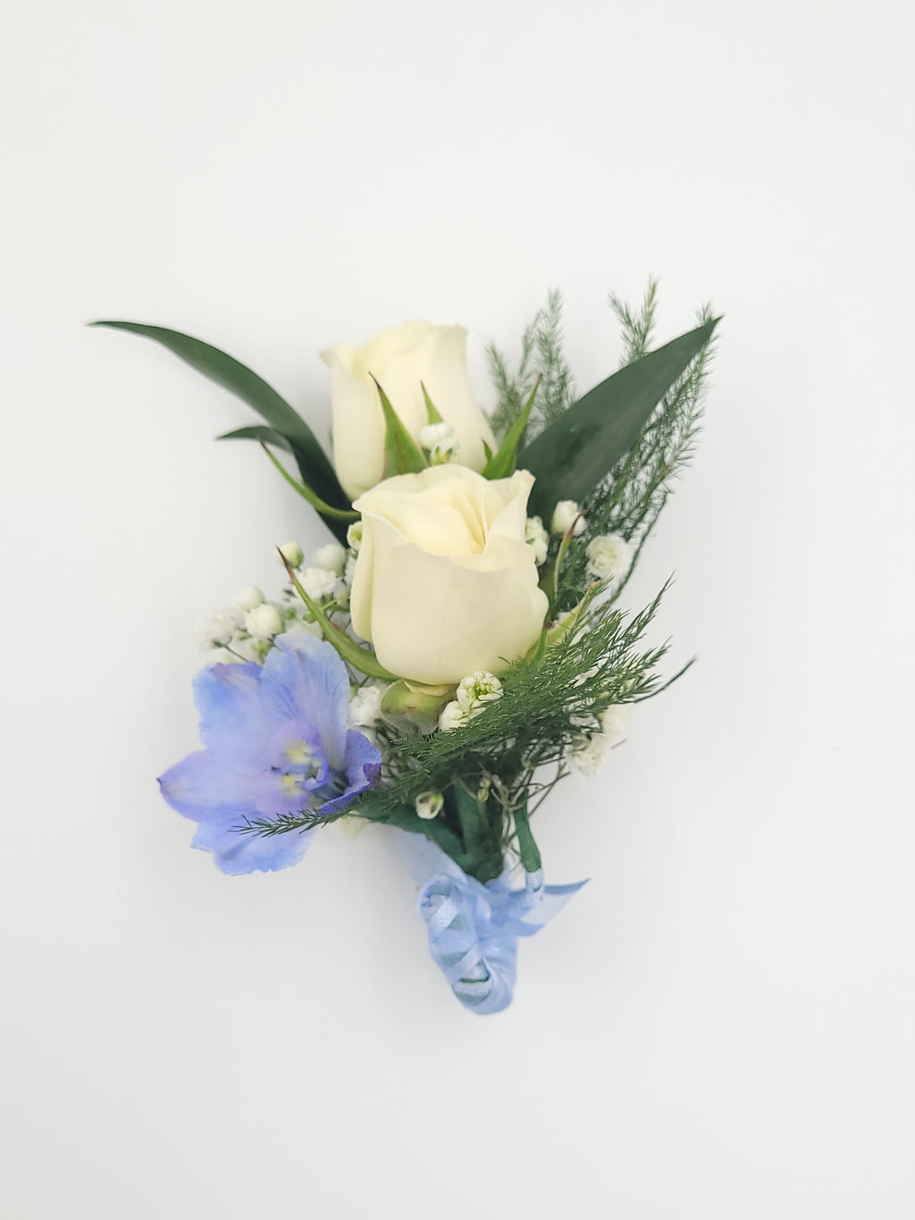Elegant boutonniere with cream roses, blue delphinium, greenery from Joshua's Greenery Barrie florist