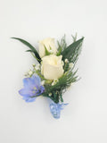 Elegant boutonniere with cream roses, blue delphinium, greenery from Joshua's Greenery Barrie florist