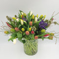 Mixed tulip bouquet in glass vase from Joshua's Greenery Barrie Florist on white background