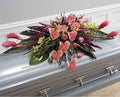 Tropical pink and green funeral casket spray by Joshua's Greenery Barrie Florist