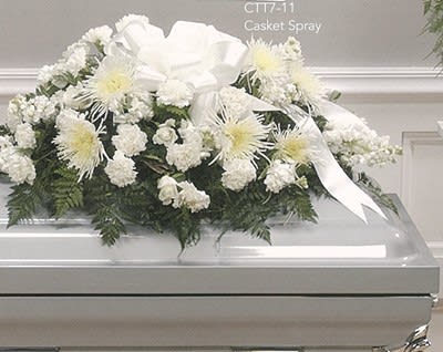 White casket spray arrangement with chrysanthemums, carnations, and ribbon from Joshua's Greenery