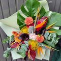 Tropical flower bouquet with monstera leaves, birds of paradise, and vibrant blooms by Barrie florist.