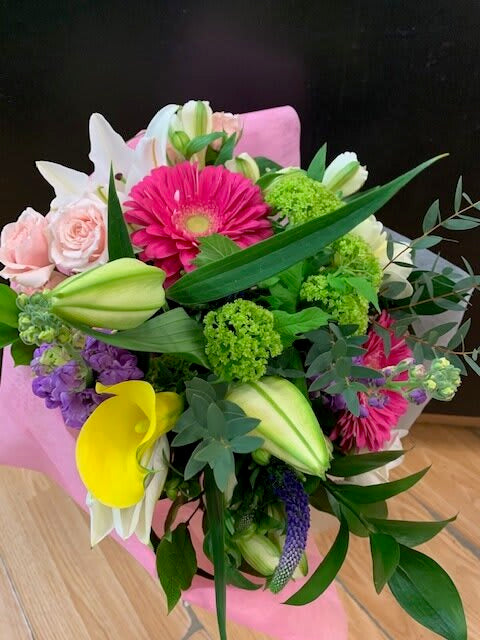 Bright mixed flower bouquet with gerbera daisies, lilies, roses, and greenery from Barrie florist