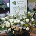 Elegant white floral arrangement with roses and greenery at Joshua's Greenery Barrie florist.
