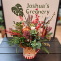 Festive holiday floral arrangement in a reindeer mug at Joshua's Greenery Barrie Florist