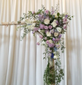 Elegant floral arch with white and lavender roses, lush greenery, wedding decor by Joshua's Greenery
